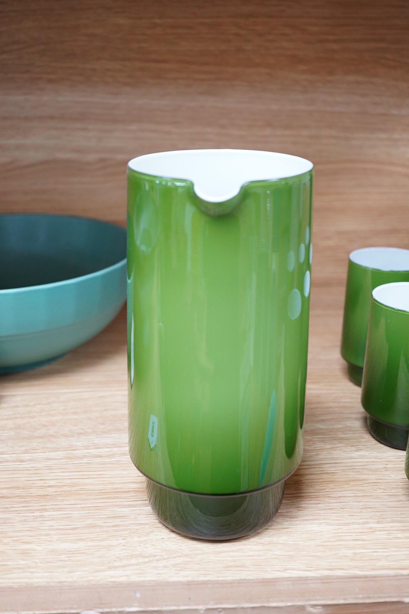 Michael Bang for Holmegaard glass, a green cased jug and six mugs with stepped bases, largest 20cm high